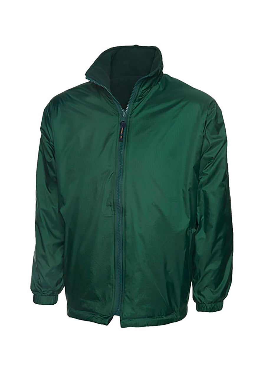 Uneek Clothing UC606 Childrens Reversible Fleece Jacket with waterproof outside in bottle green with full zip fastening and two lower pockets.