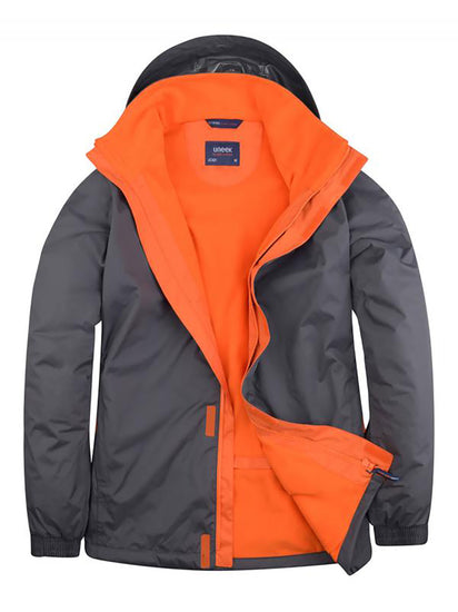 Uneek Clothing UC621 - Deluxe Outdoor Jacket in deep grey with hood with fiery orange fleece lining, full front zip and flap with velcro.