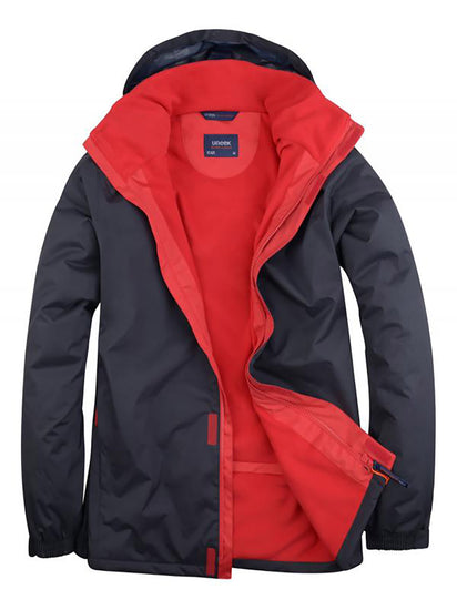 Uneek Clothing UC621 - Deluxe Outdoor Jacket in navy with hood with red fleece lining, full front zip and flap with velcro.